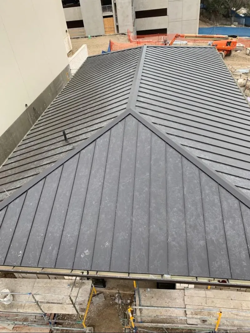 Commercial metal roof construction with crane equipment in The Acreage