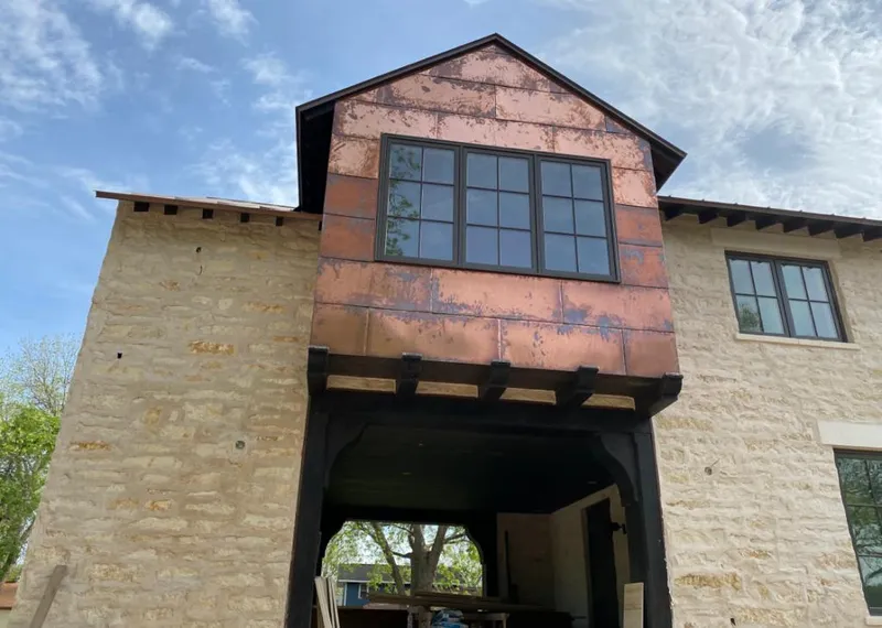 Copper metal panel facade on a stone building for Roof Repair in The Acreage